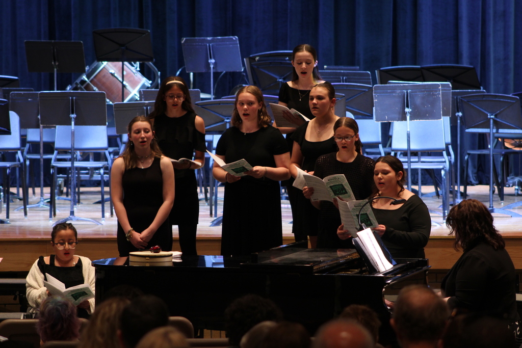 students singing in choir on risers