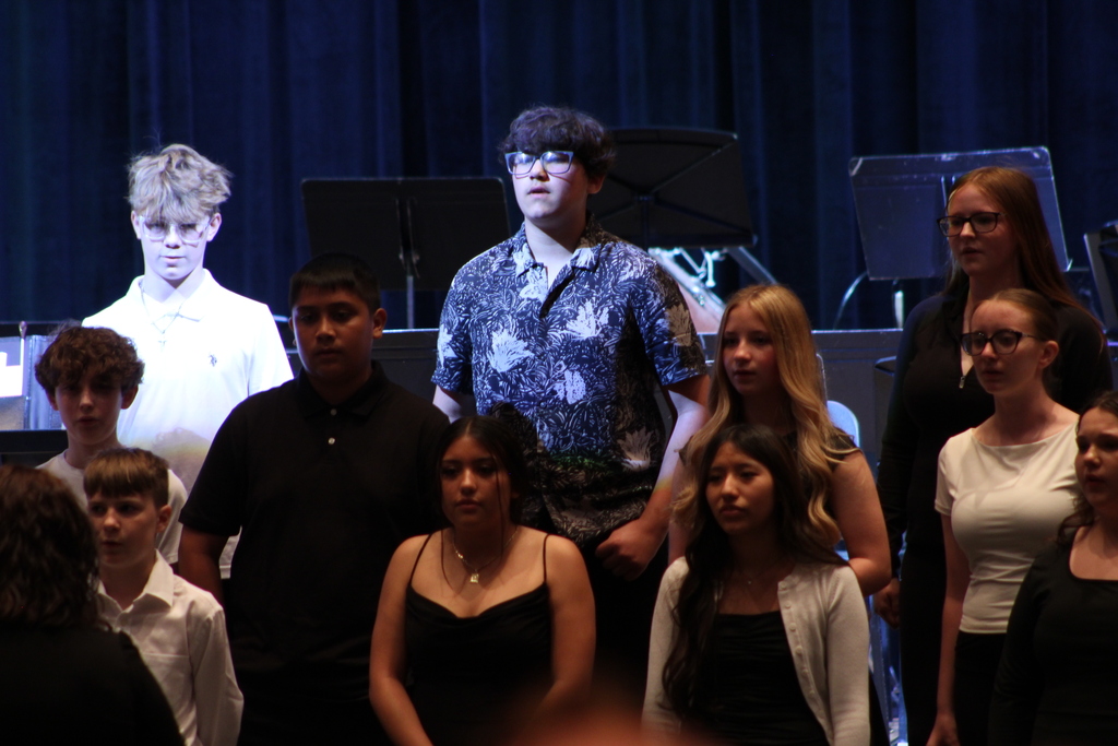 students singing in chorus on risers
