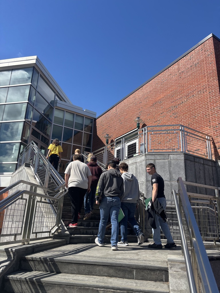 students walking up outdoor staricase on college campus