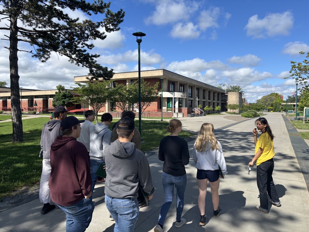 students walking down sidewalk on college campus
