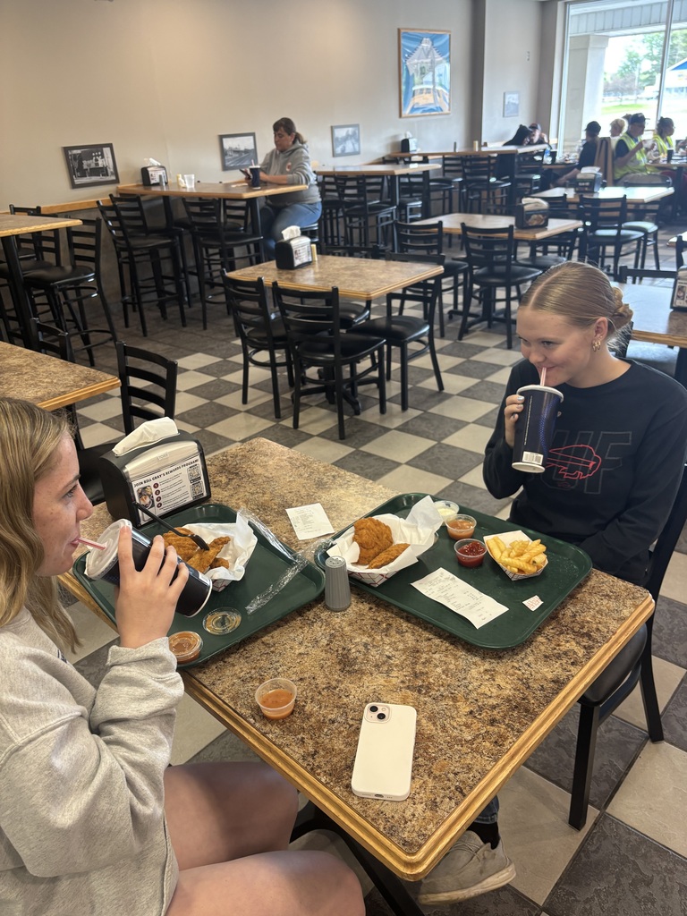 students eating at a table in restaurant