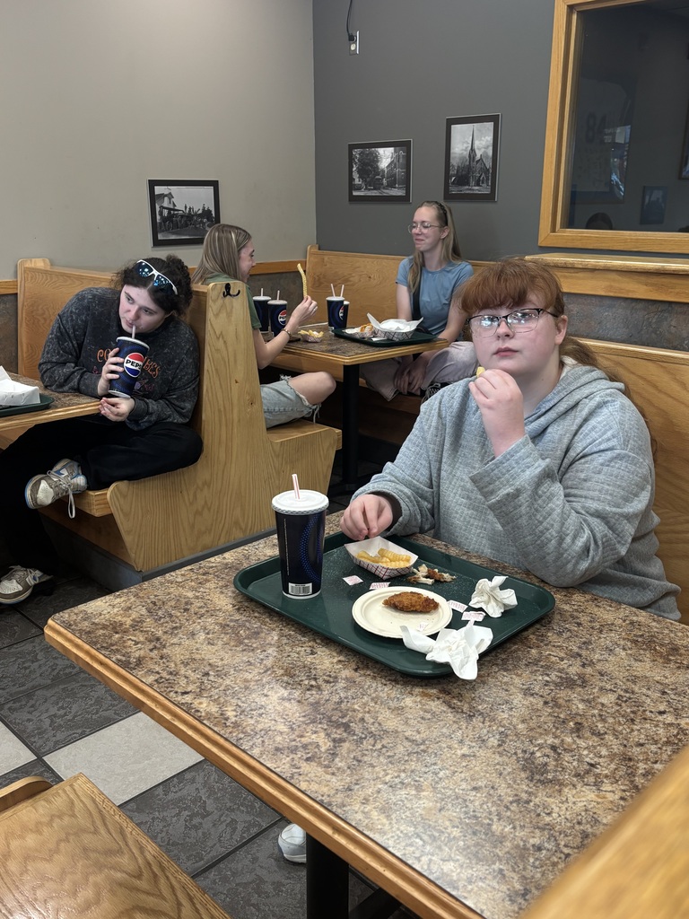 students eating at tables in restaurant