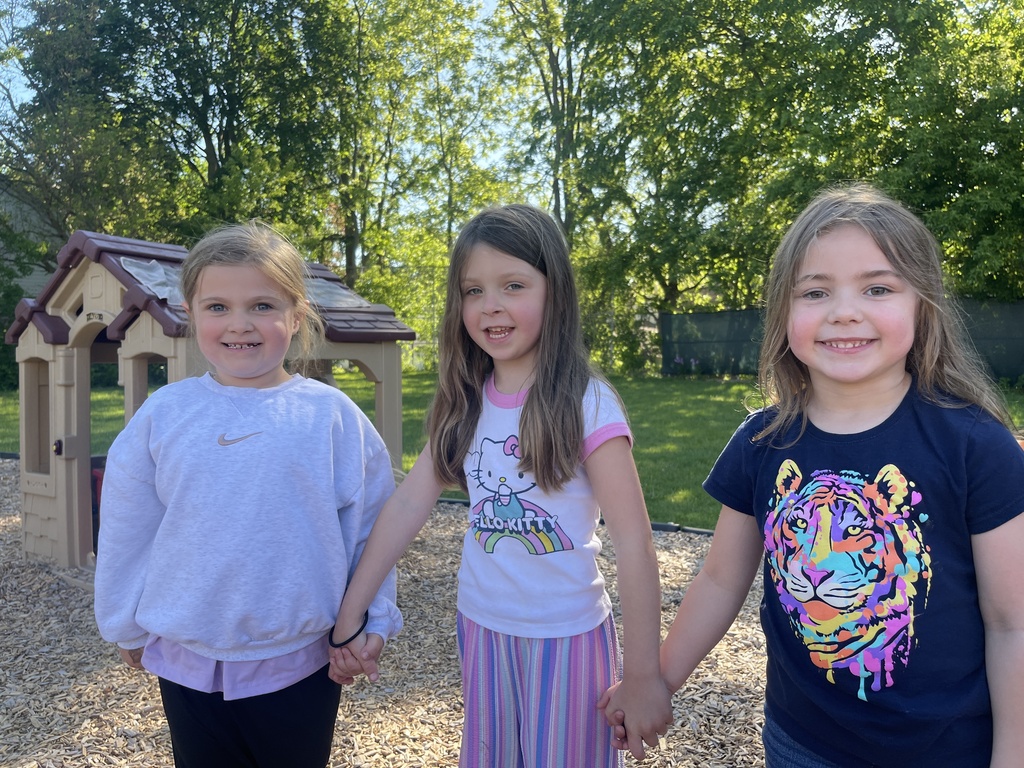 three girls holding hands on playground