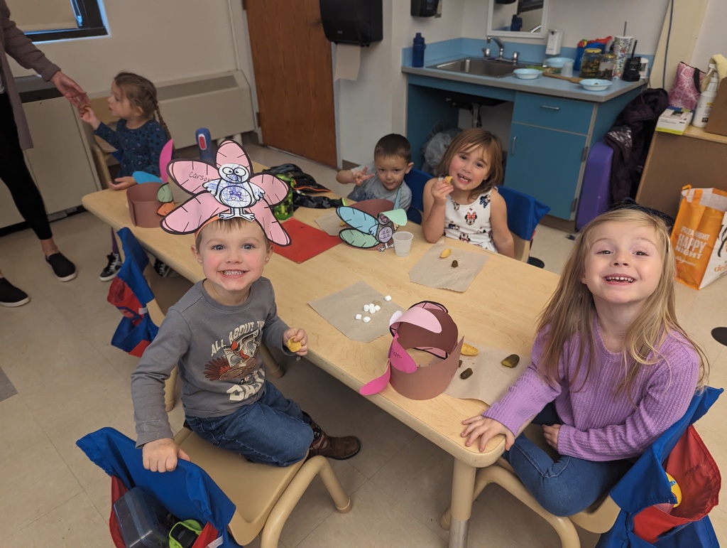 students sitting at table earing