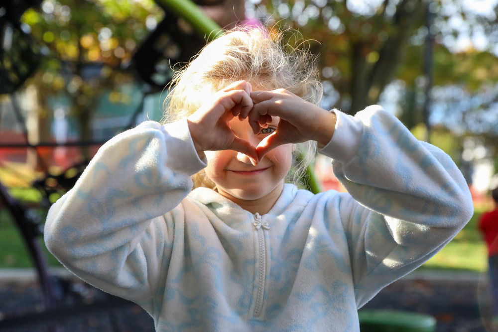 girl posing with heart hands