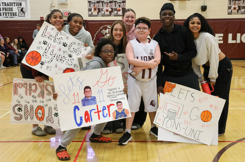 students posing with player