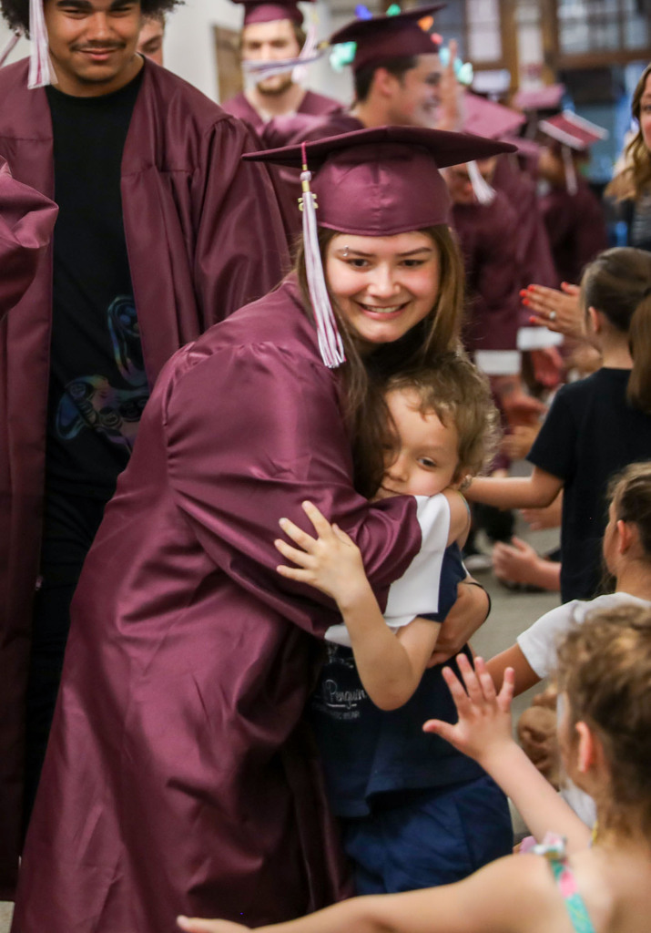senior hugging student 