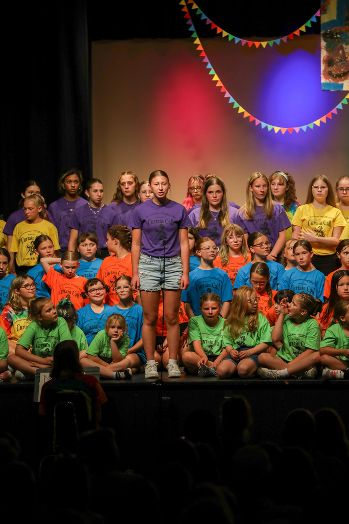 student singing at curtain call