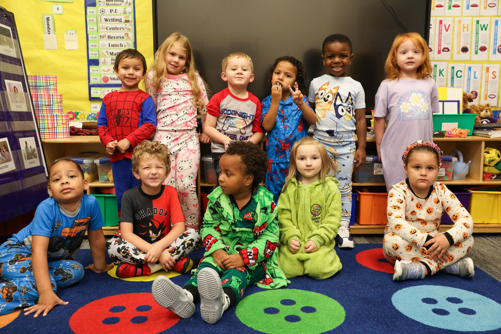 younger students on the rug
