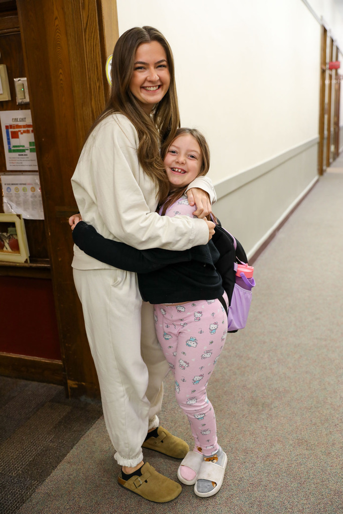 student and teacher hugging