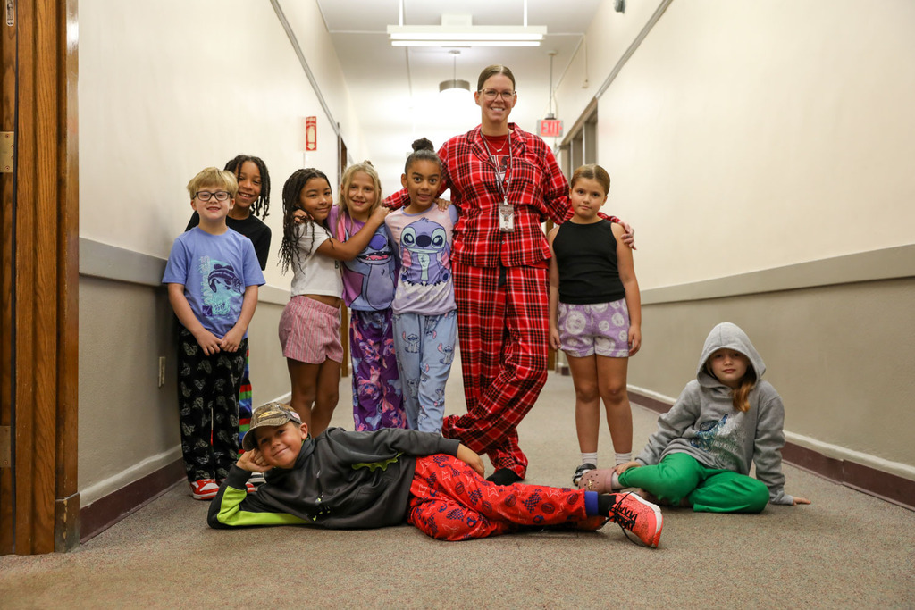 teacher and students in hallways in pajamas