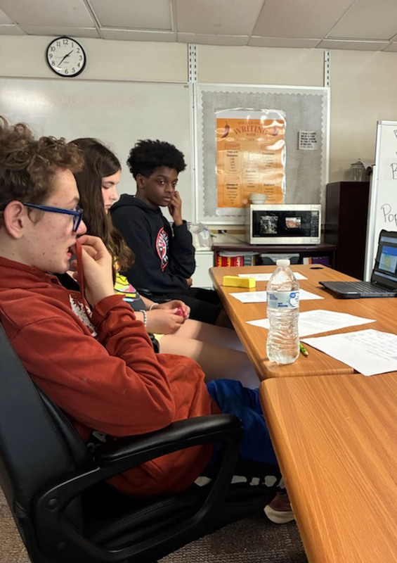 students looking at computer