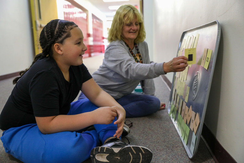 Ms. Mares and student working