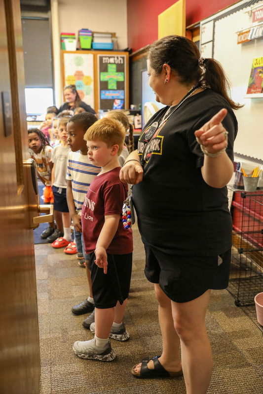 students with teacher on moving up day