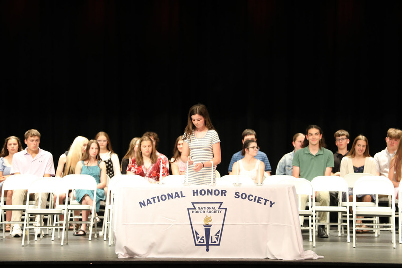 lighting candle at honor society ceremony