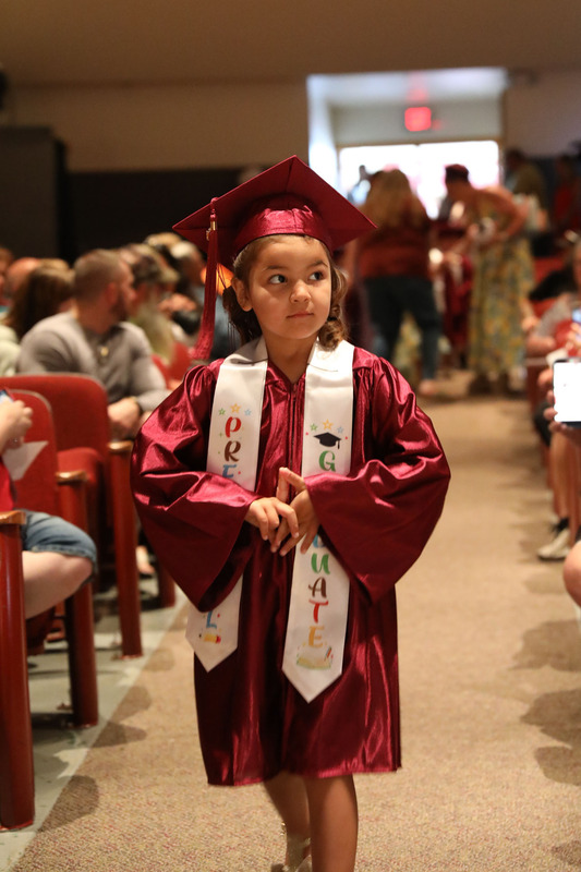 graduate walking down isle