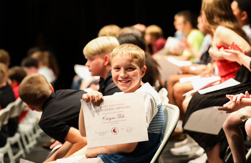 5th grader with diploma