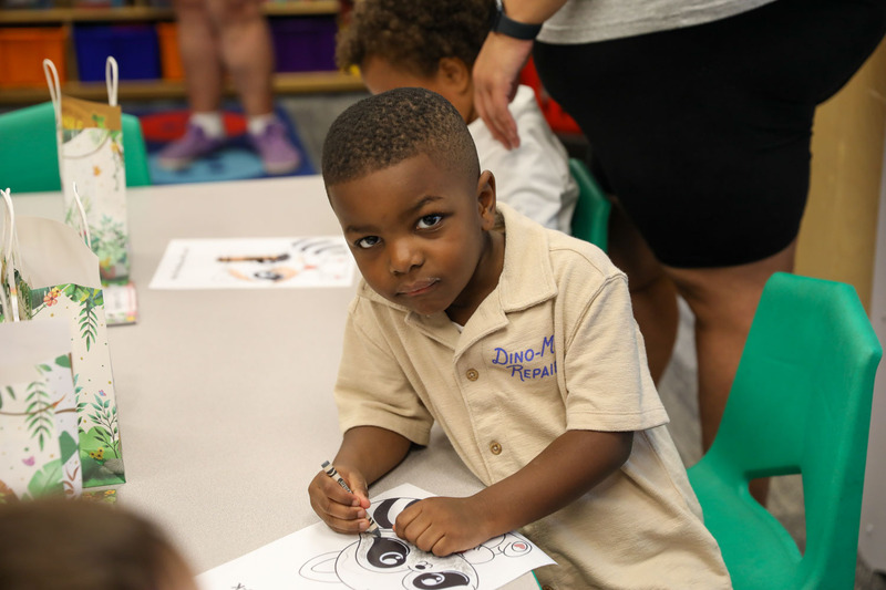 student in classroom coloring