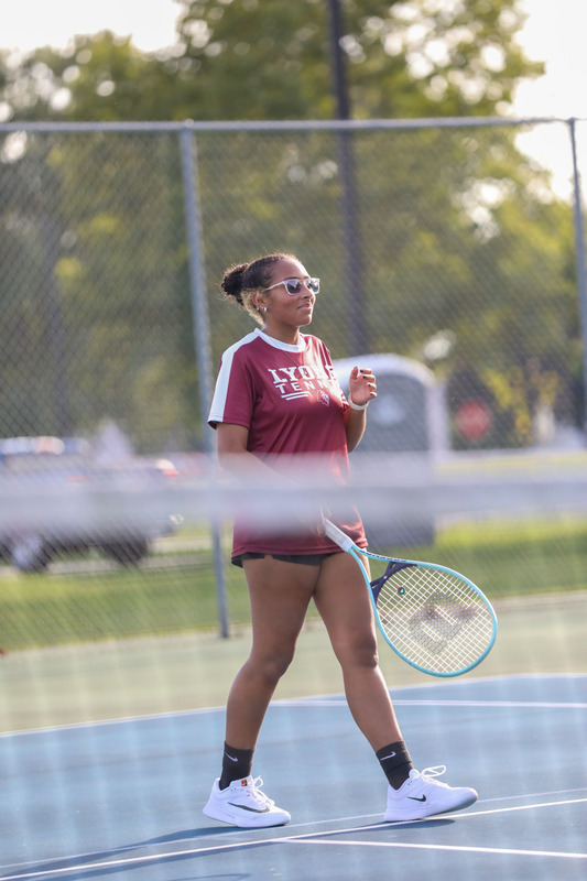 varsity girls tennis player on court