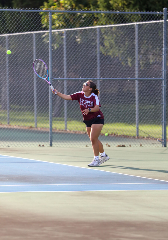 tennis player hitting ball