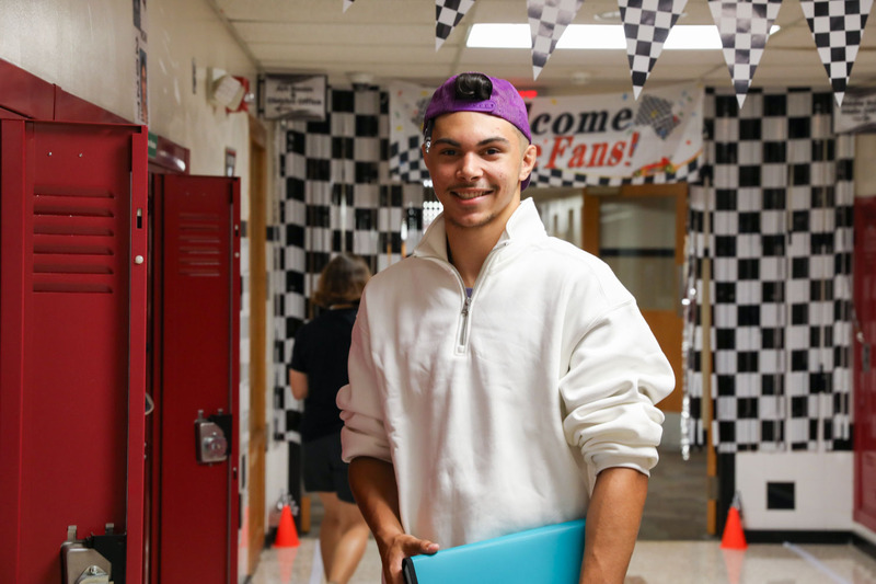 senior in decorated hallway