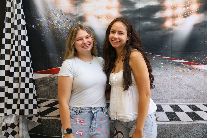 students posing in front of backdrop