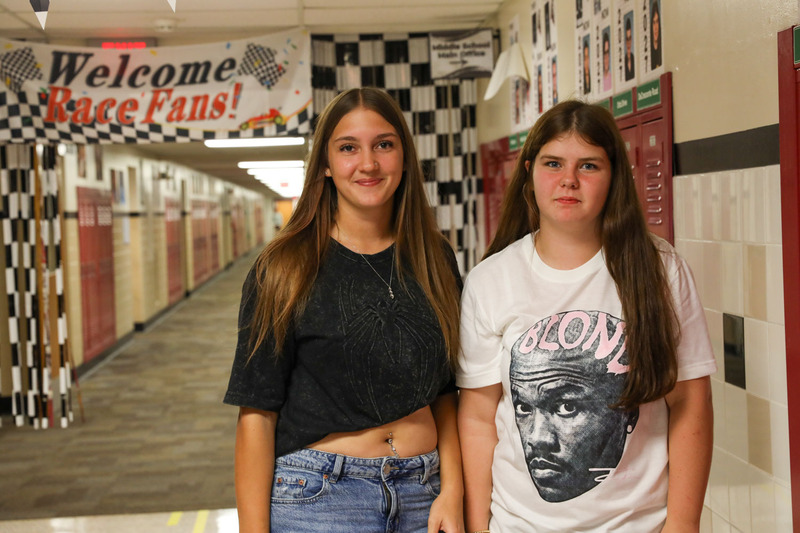 two girls posing in decorated hallway