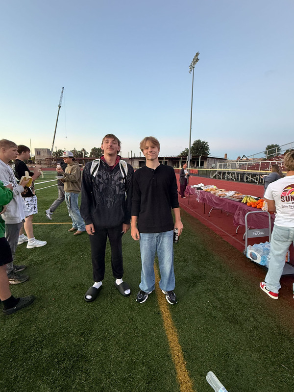 students posing on football field