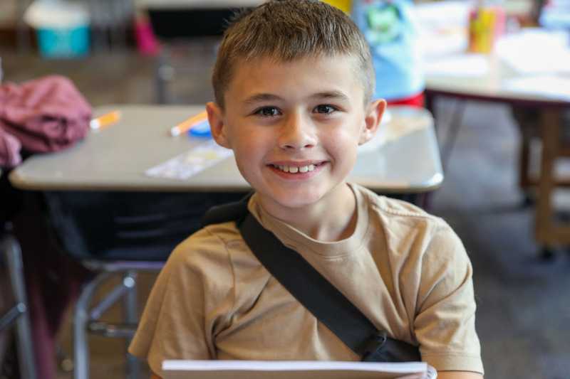 student smiling at desk