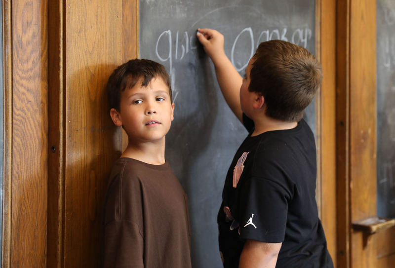 student drawing on chalkboard