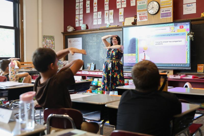 teacher doing the equals hand signal