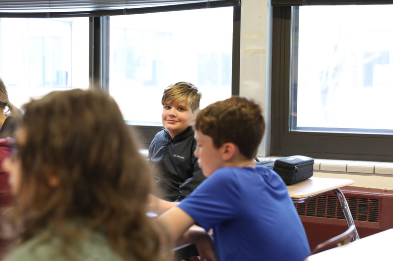 student at desk smiling