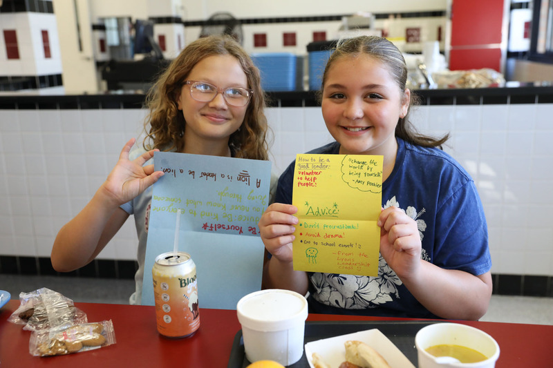 students showing their cards