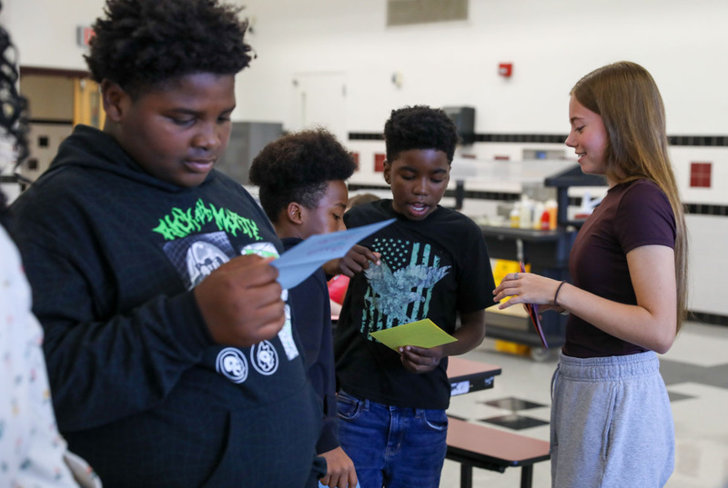 students receiving their cards