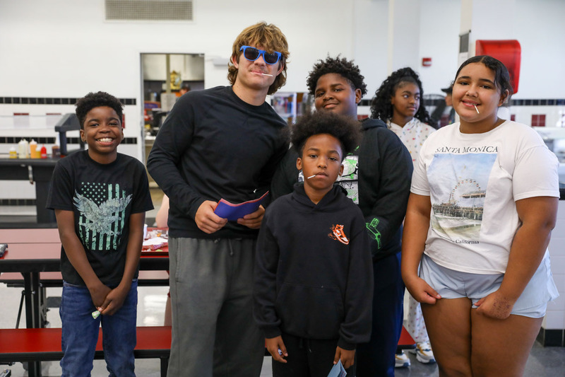 students posing together in cafeteria