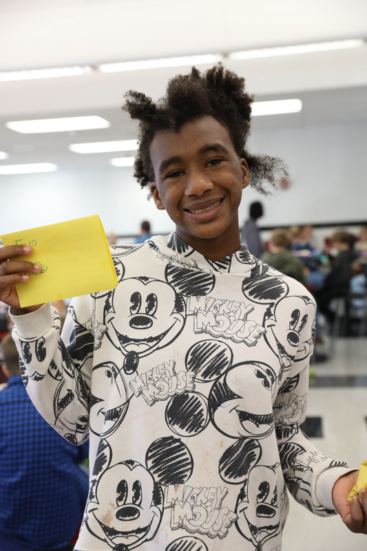 student posing with card