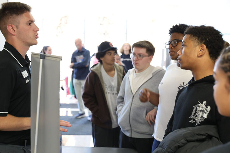 students talking to college rep
