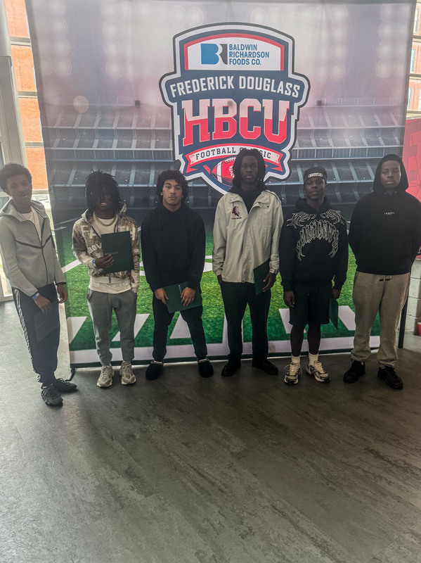 students posing in front of HBCU banner
