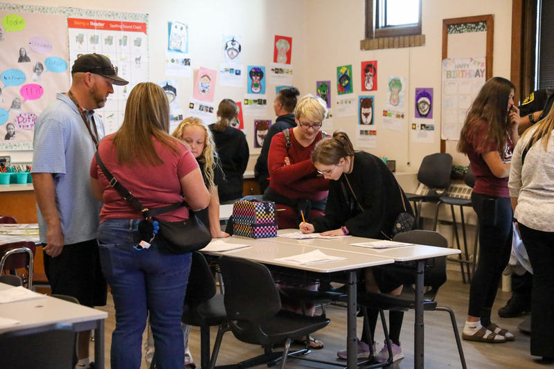 students with their parents in the classroom