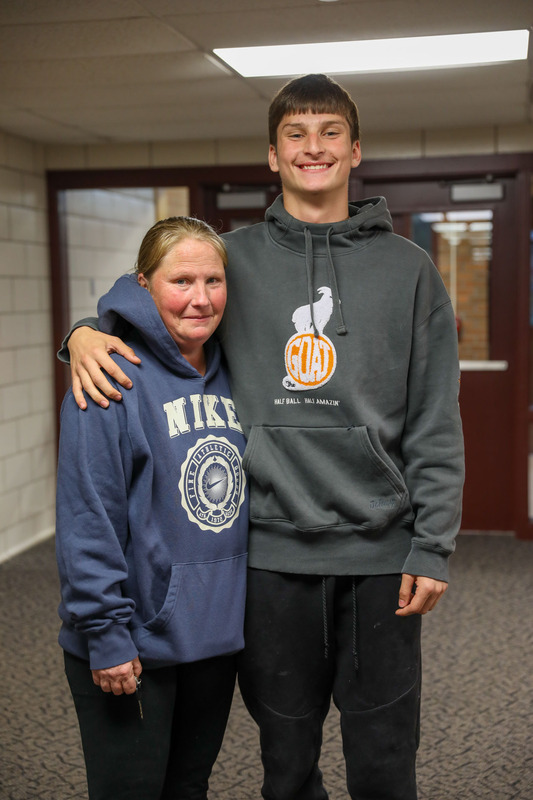 student posing with family