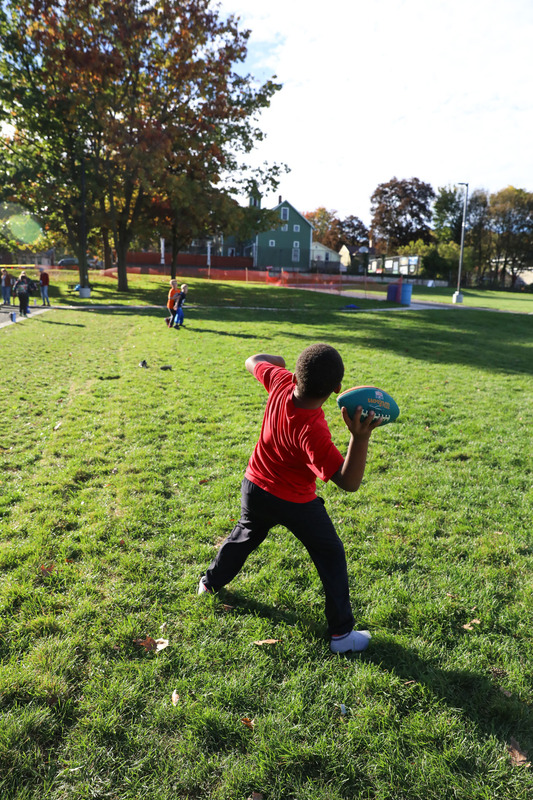 boy throwiing a football