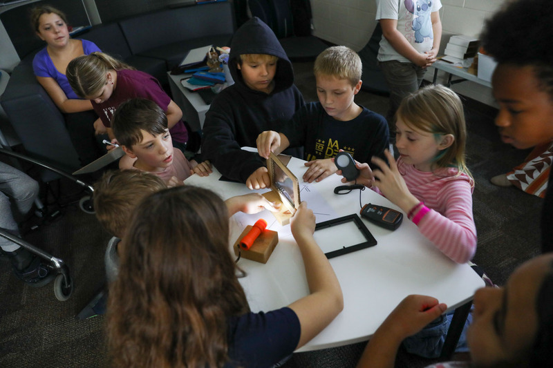 students in a group working on reflecting lab