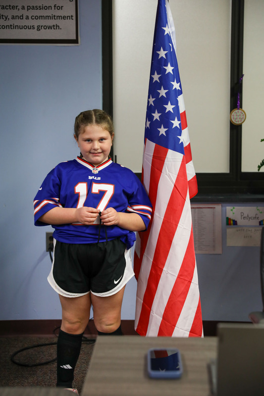 kinsley posing in front of the flag