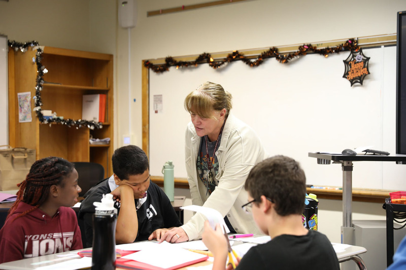 teacher helping students