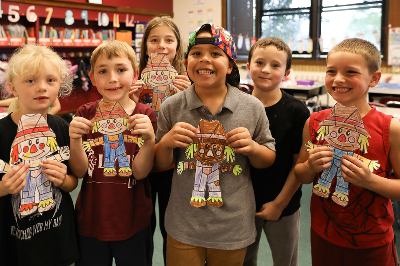 group of students holding their math scarecrows