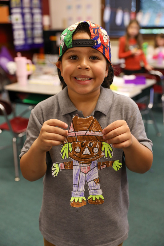 student holding math scarecrow