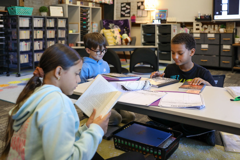 students reading at book club