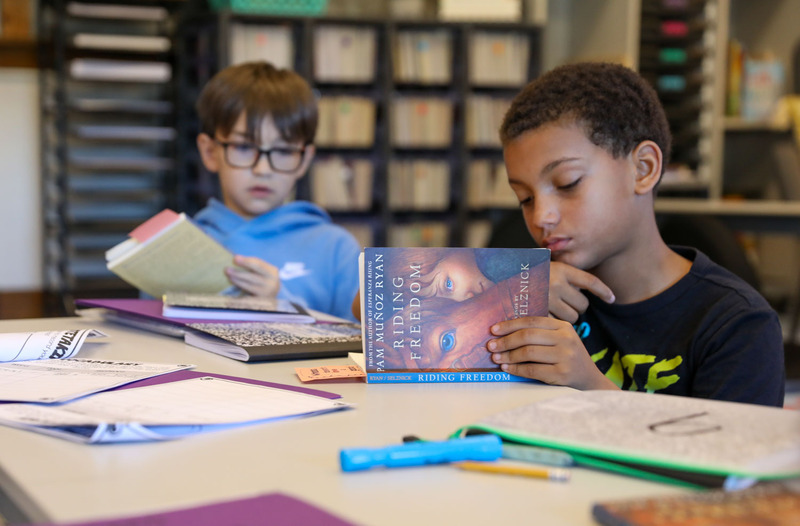 students reading their books