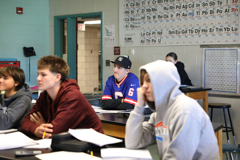 student sitting at desk paying attention