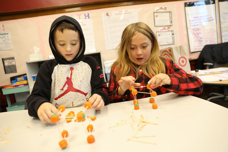 students building pumpkin structures